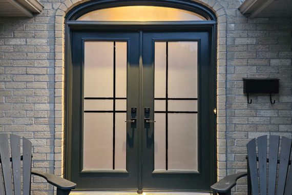 A black steel double door with curved transom from Gentek Entryguard.