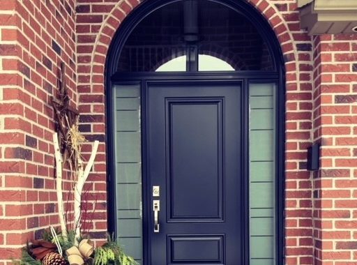 A solid slab door with sidelites and transom installed by Heritage Renovations in London, Ontario, and manufactured by Gentek.